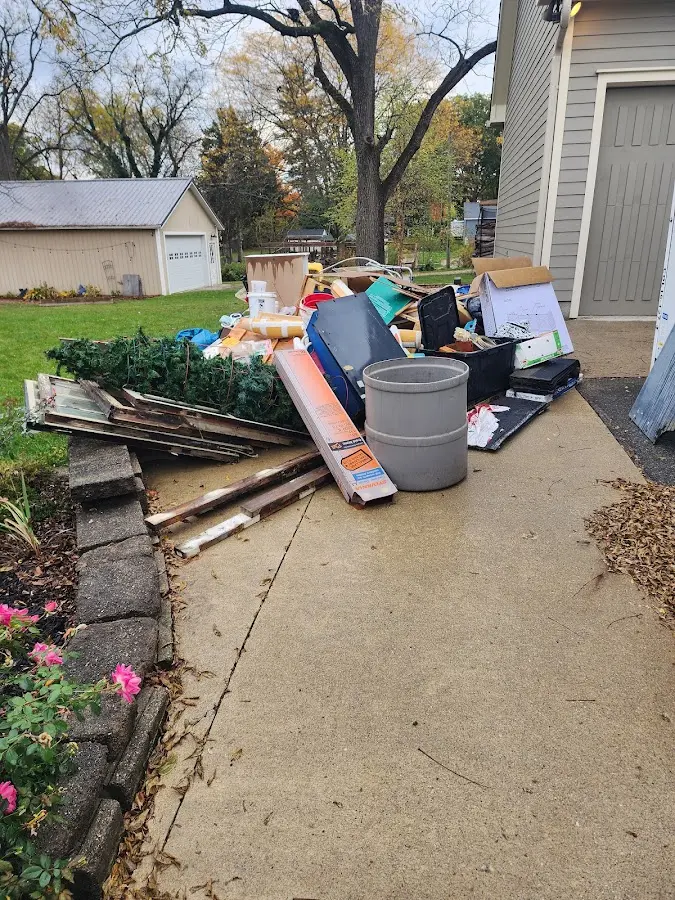 Dumpster being loaded with debris for 30 Yard Dumpster Rental in Satsuma